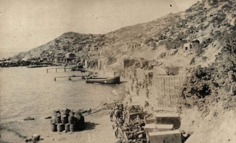 View of Anzac Cove looking towards Ari Burnu. Note the stores, supply dumps and William's Pier.